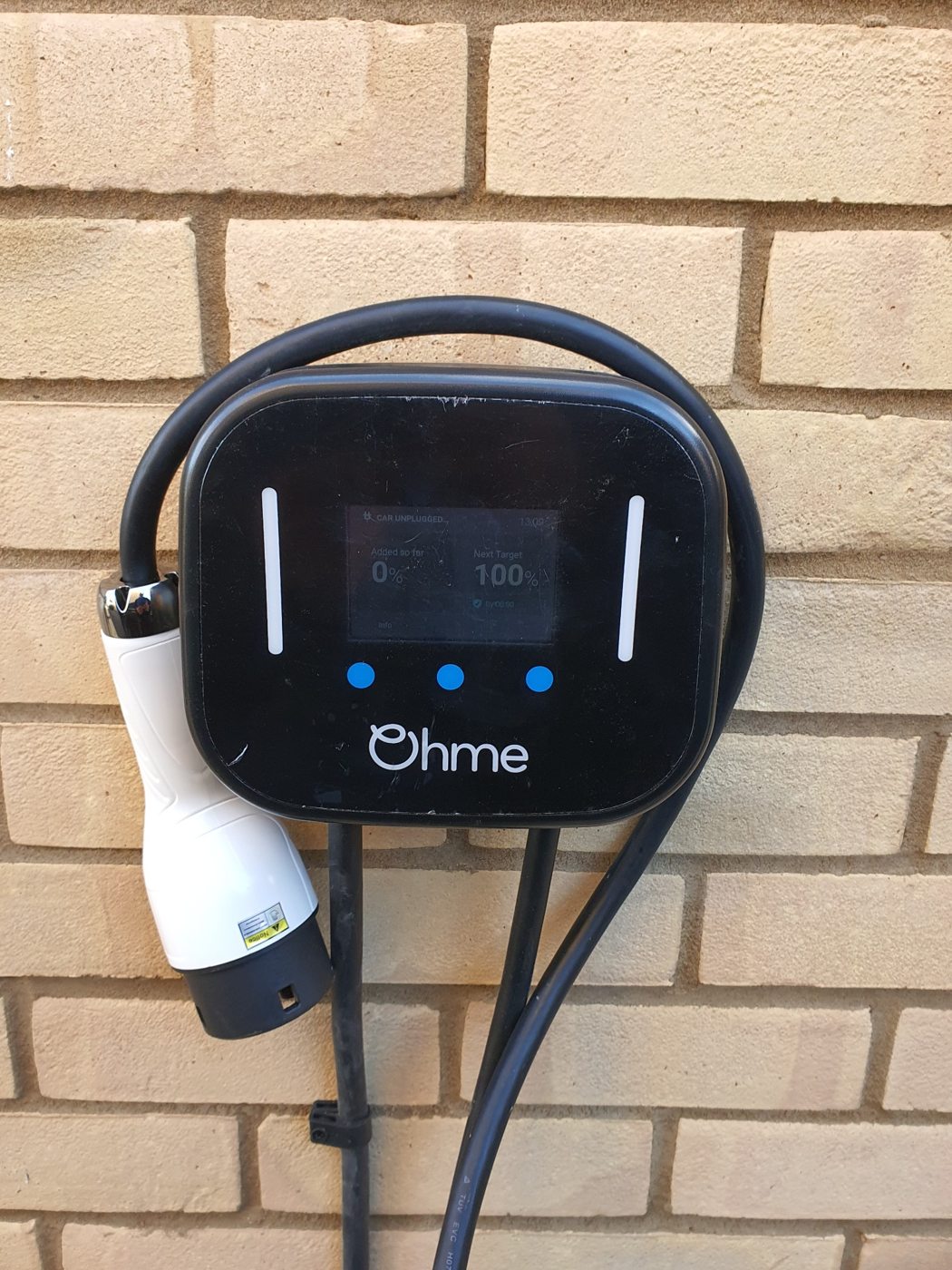 Wall-mounted Ohme electric vehicle charger installed at a home